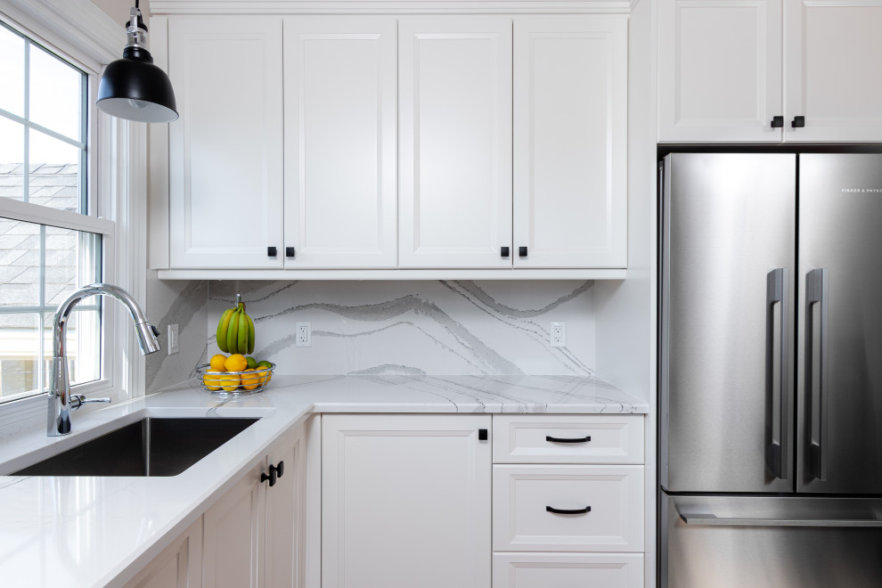 Example of a transitional kitchen design with white cabinets, quartz countertops, white backsplash, quartz backsplash and white countertops
