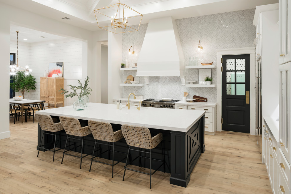 Example of a huge transitional galley light wood floor and beige floor open concept kitchen design in Phoenix with an undermount sink, shaker cabinets, white cabinets, quartz countertops, gray backsplash, marble backsplash, stainless steel appliances and an island
