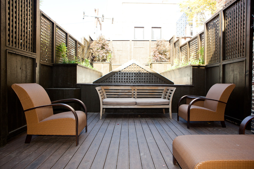 This is an example of a mid-sized traditional rooftop deck in Chicago with a pergola.