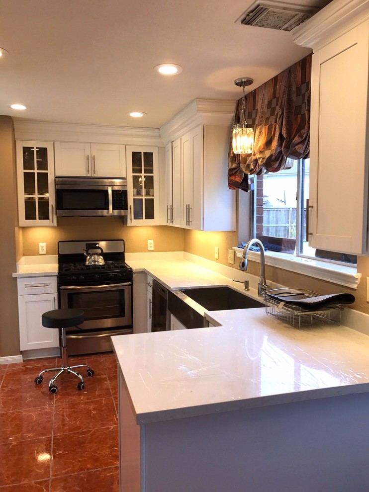 Inspiration for a mid-sized transitional l-shaped red floor enclosed kitchen remodel in Houston with a farmhouse sink, shaker cabinets, white cabinets, stainless steel appliances, no island, quartzite countertops, white backsplash and stone slab backsplash