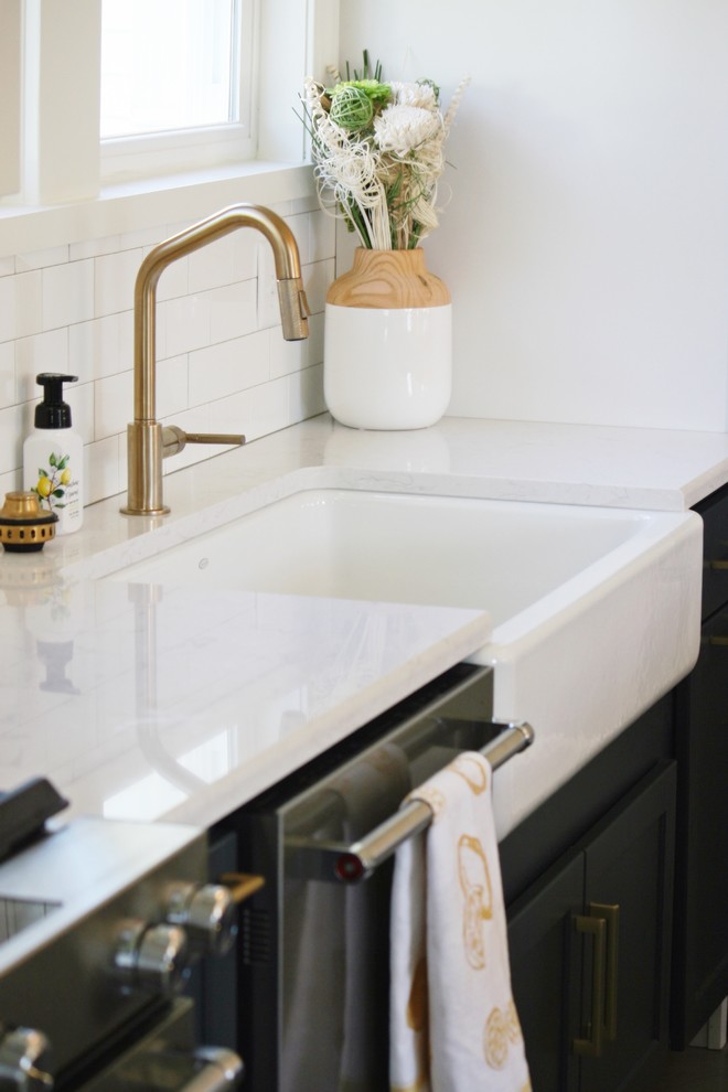Kitchen - transitional gray floor kitchen idea with a farmhouse sink, quartz countertops and stainless steel appliances