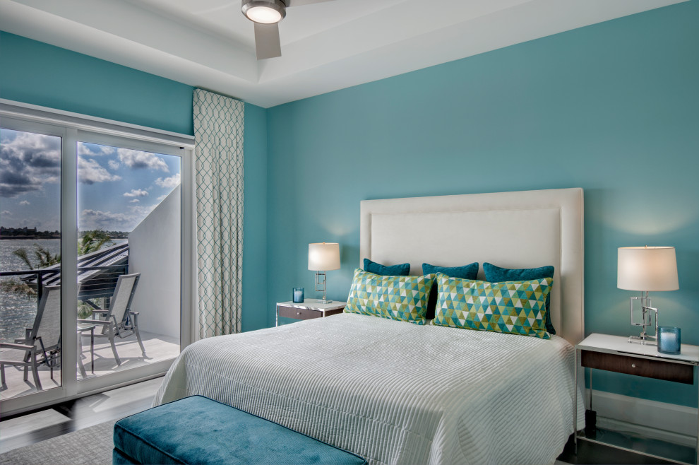 Mid-sized contemporary guest bedroom in Miami with blue walls and dark hardwood floors.