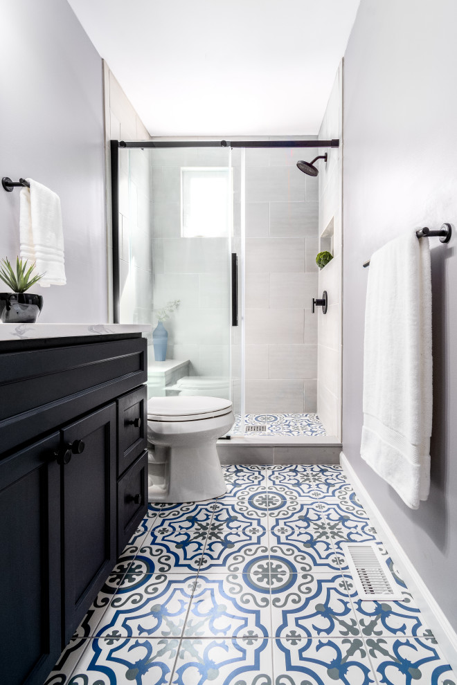 Photo of a small traditional shower room bathroom in Philadelphia with shaker cabinets, black cabinets, an alcove shower, a two-piece toilet, grey tiles, ceramic tiles, grey walls, ceramic flooring, a submerged sink, granite worktops, blue floors, a shower curtain, white worktops, a shower bench, a single sink and a freestanding vanity unit.