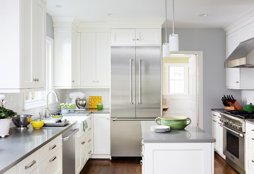 Under-counter dishwasher beside the sink in a white shaker RTA kitchen, showing the standard 24-inch opening and adjacent plumbing/electrical access