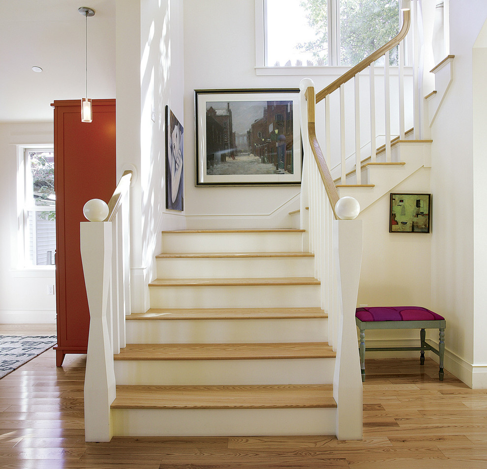 Inspiration for a transitional wood u-shaped staircase in Portland Maine with painted wood risers.