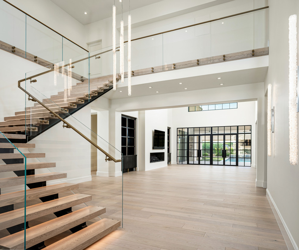 Staircase - huge modern wooden floating open and glass railing staircase idea in Phoenix