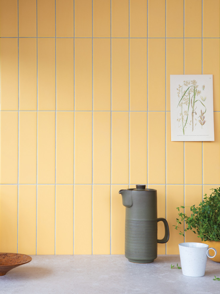 This is an example of a midcentury kitchen in London with yellow splashback and ceramic splashback.
