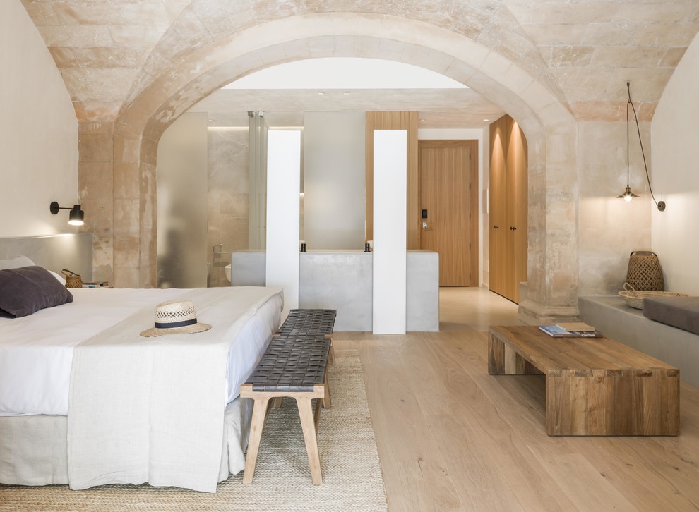 Design ideas for a mediterranean bedroom in Turin with beige walls, light hardwood floors and beige floor.