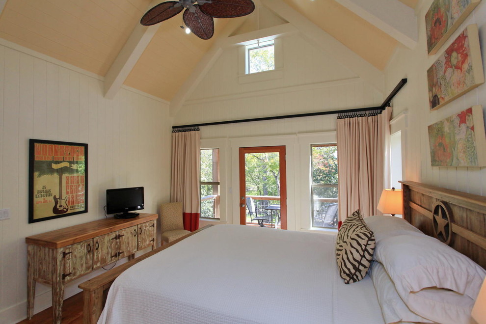 This is an example of a traditional bedroom in Austin with white walls and no fireplace.