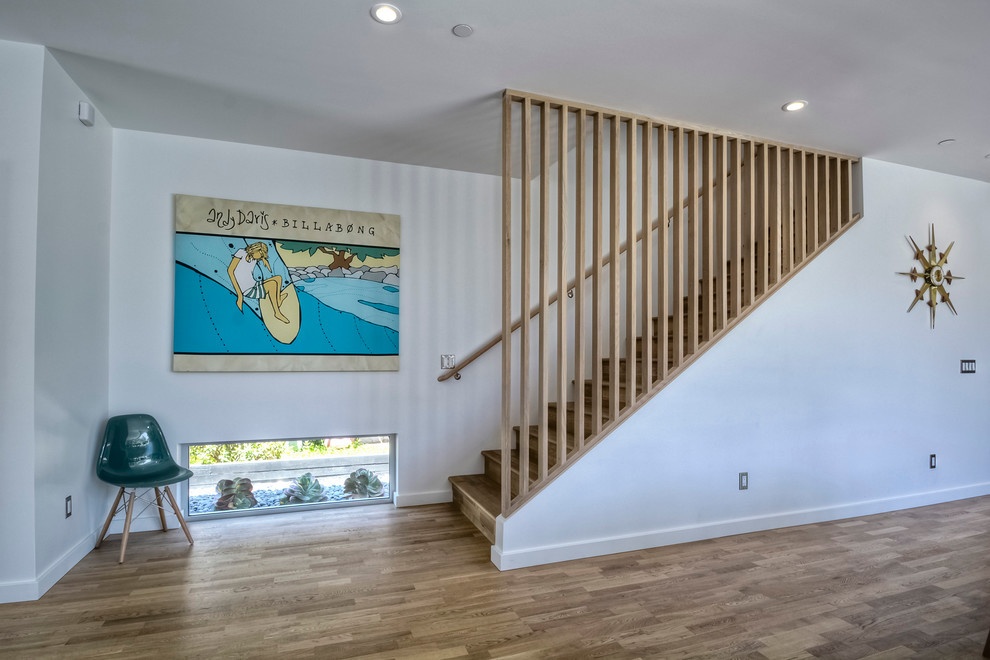 Photo of a contemporary wood straight staircase in San Diego with wood risers.