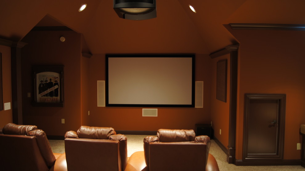 Inspiration for a large traditional enclosed home theatre in Other with carpet, a projector screen and brown walls.