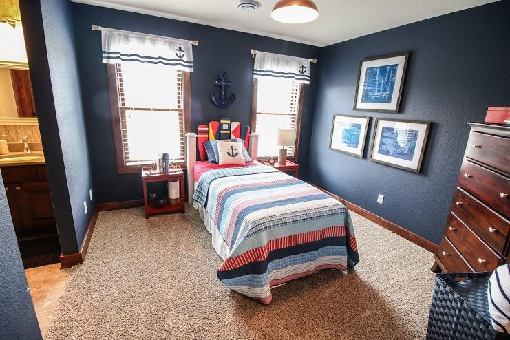 Design ideas for a mid-sized beach style guest bedroom in Milwaukee with blue walls and carpet.