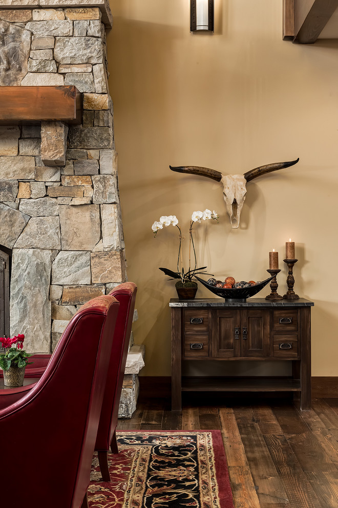 Inspiration for a large craftsman open concept medium tone wood floor living room remodel in Calgary with yellow walls, a standard fireplace, a stone fireplace and no tv