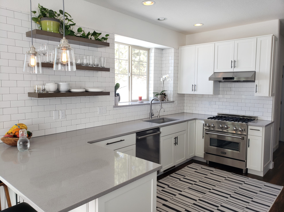 Kitchen - large transitional u-shaped brown floor kitchen idea with an undermount sink, shaker cabinets, white cabinets, white backsplash and gray countertops