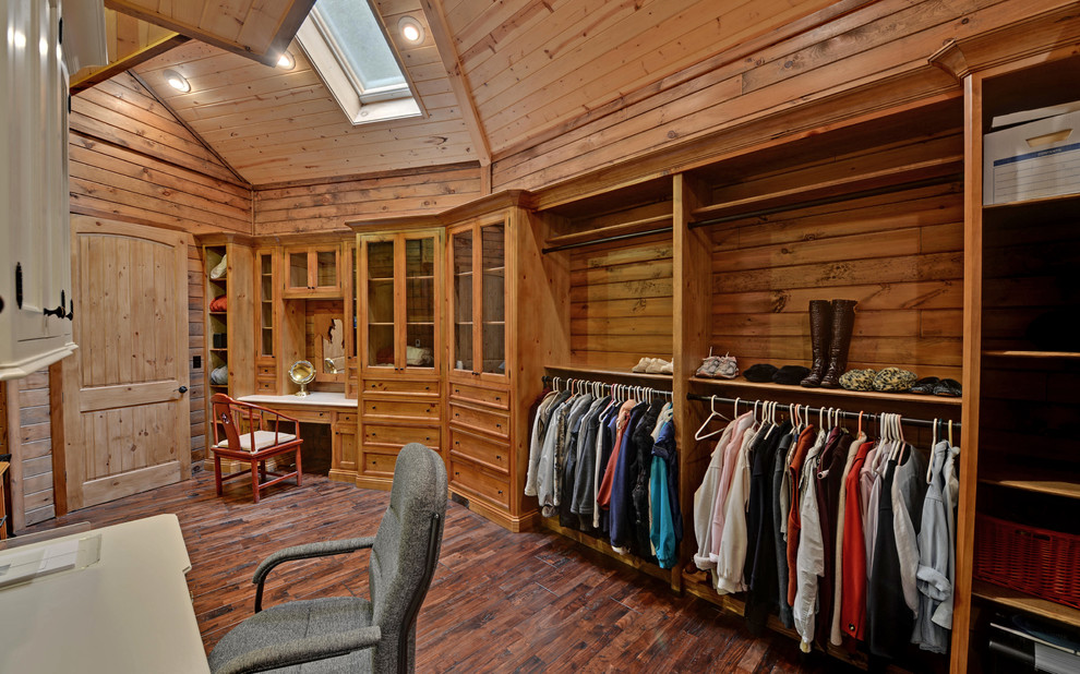 Inspiration for a traditional walk-in wardrobe in Atlanta with dark hardwood floors.