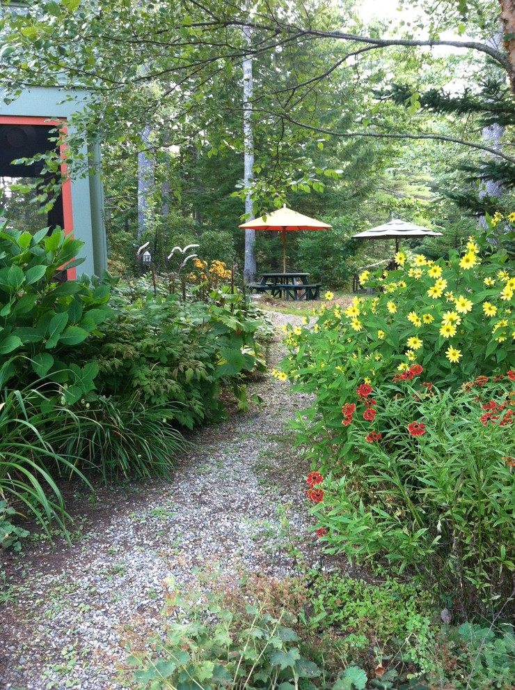 Inspiration for a large country backyard partial sun formal garden in Portland Maine with a garden path and mulch.