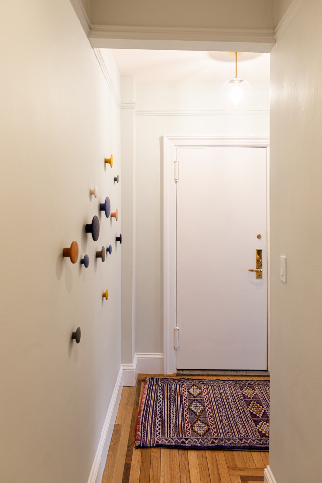 Small midcentury hallway in Los Angeles with grey walls, beige floor and light hardwood floors.
