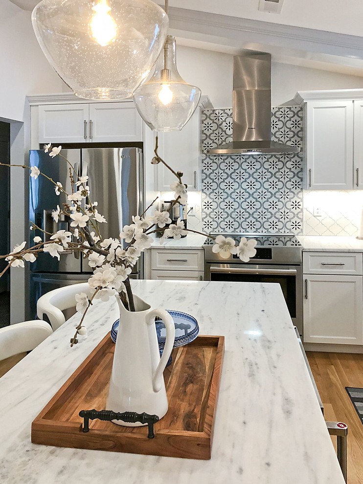 Inspiration for a transitional light wood floor eat-in kitchen remodel in Boston with an island