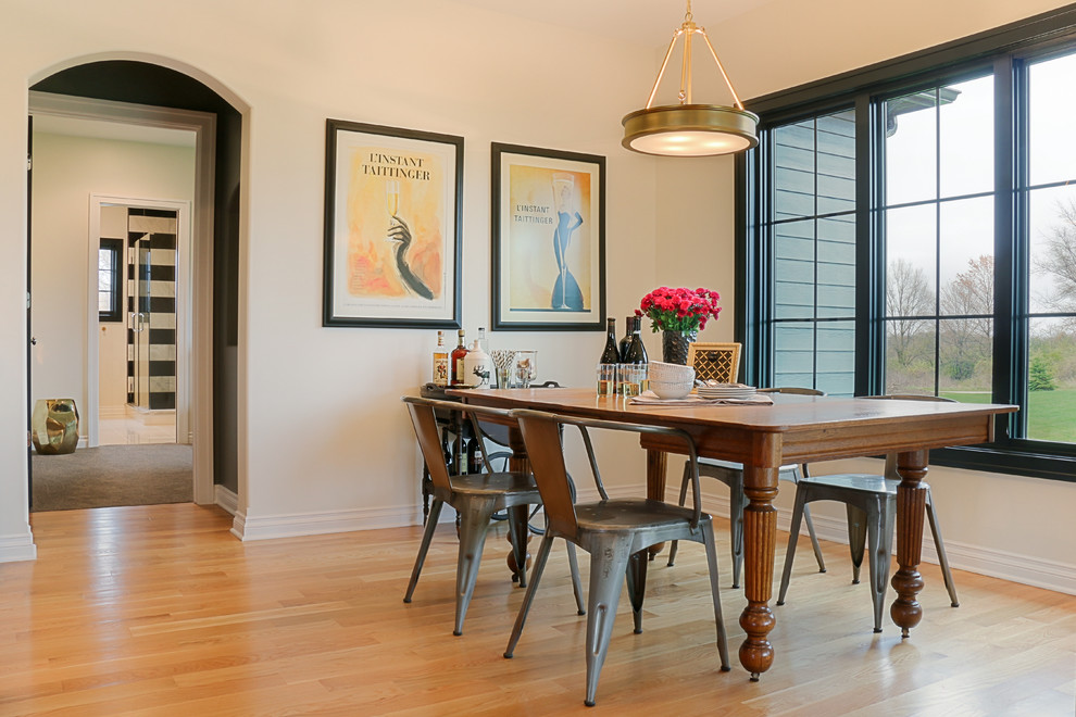 Photo of a mid-sized transitional dining room in Chicago with beige walls and light hardwood floors.