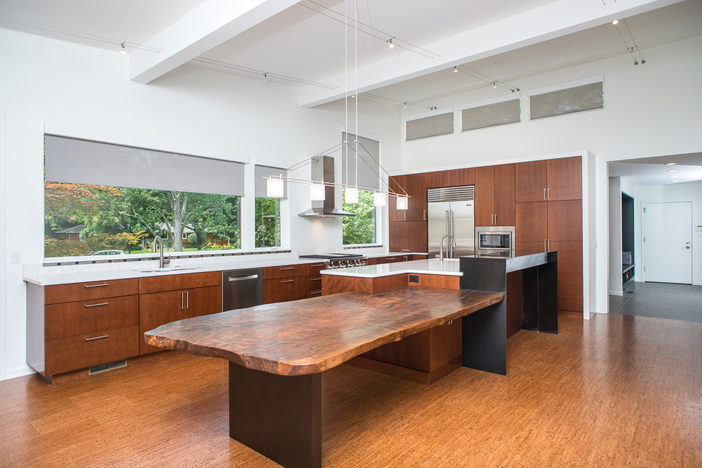 Photo of a large asian l-shaped eat-in kitchen in Detroit with a double-bowl sink, flat-panel cabinets, medium wood cabinets, quartzite benchtops, white splashback, stone slab splashback, stainless steel appliances, cork floors and with island.
