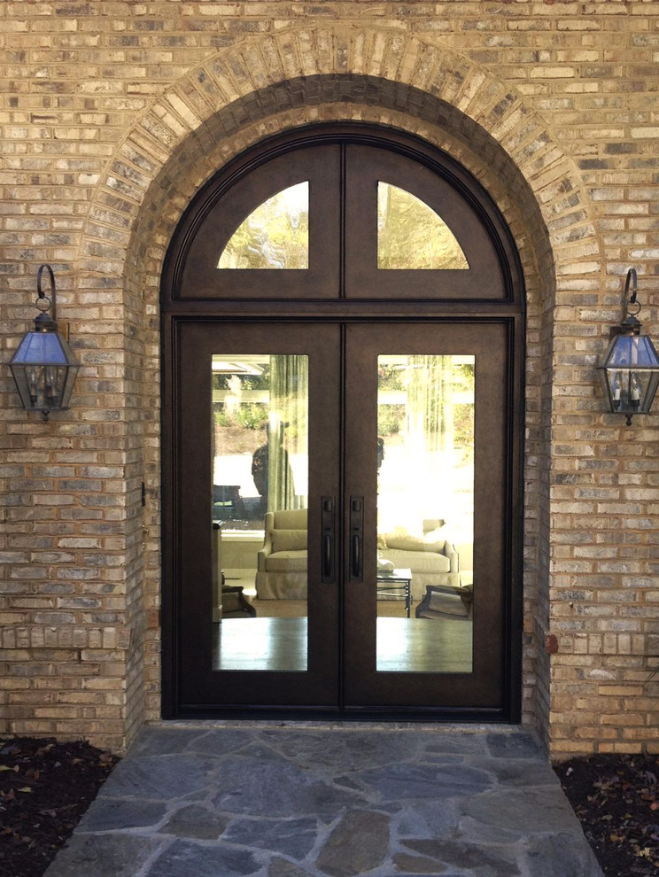 Design ideas for a large contemporary front door in Charlotte with a double front door, brown walls, slate floors and a metal front door.