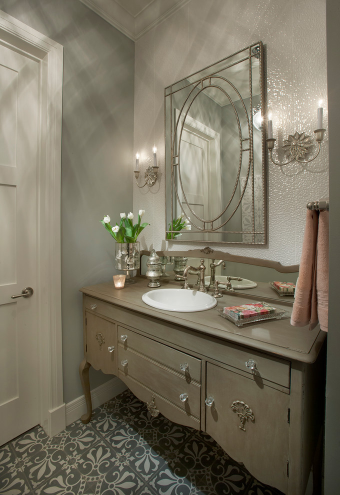 Design ideas for a traditional powder room in Phoenix with furniture-like cabinets, a drop-in sink, grey walls and brown cabinets.