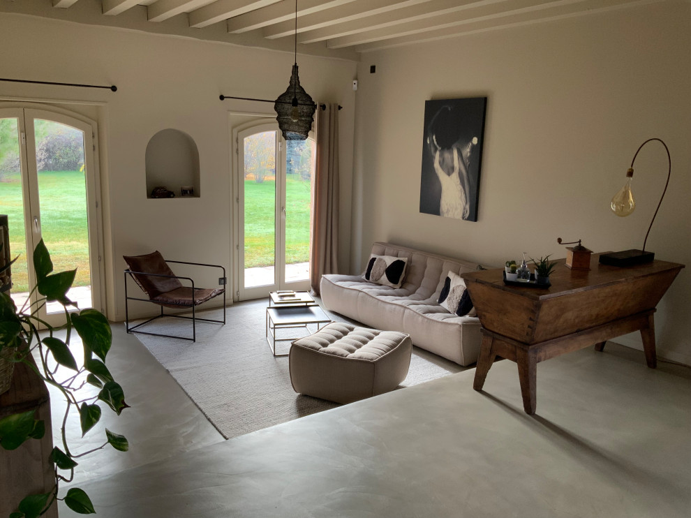 Example of a mid-sized transitional open concept concrete floor, beige floor and exposed beam living room design in Grenoble with beige walls, no fireplace and a tv stand