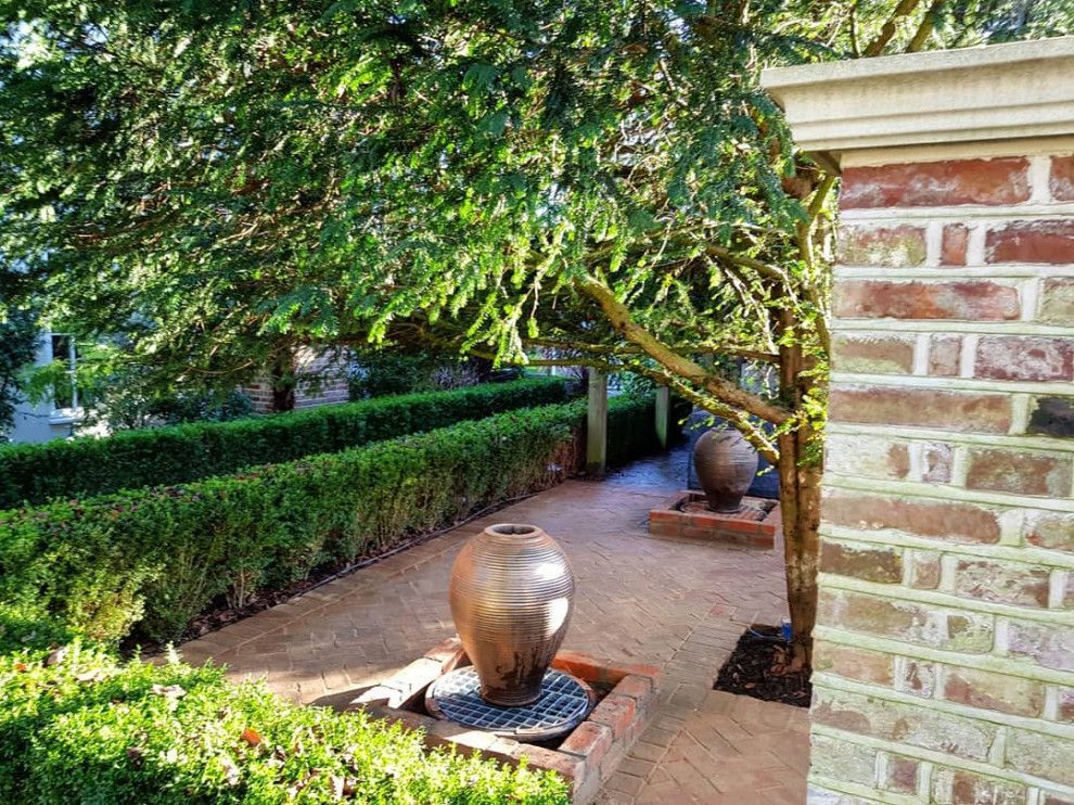 Mid-sized traditional backyard partial sun formal garden in Buckinghamshire with brick pavers for summer.