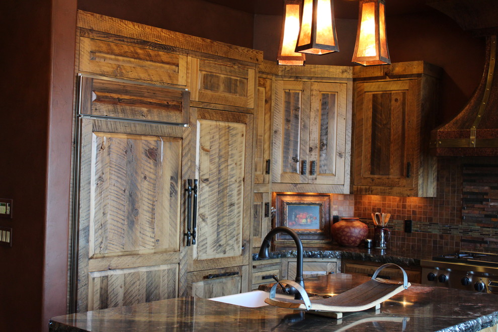 Inspiration for a mid-sized rustic u-shaped medium tone wood floor eat-in kitchen remodel with a farmhouse sink, raised-panel cabinets, distressed cabinets, granite countertops, multicolored backsplash, glass tile backsplash, paneled appliances and an island