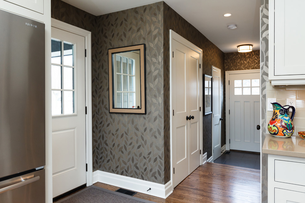 Design ideas for a mid-sized transitional hallway in Toronto with grey walls, medium hardwood floors and brown floor.