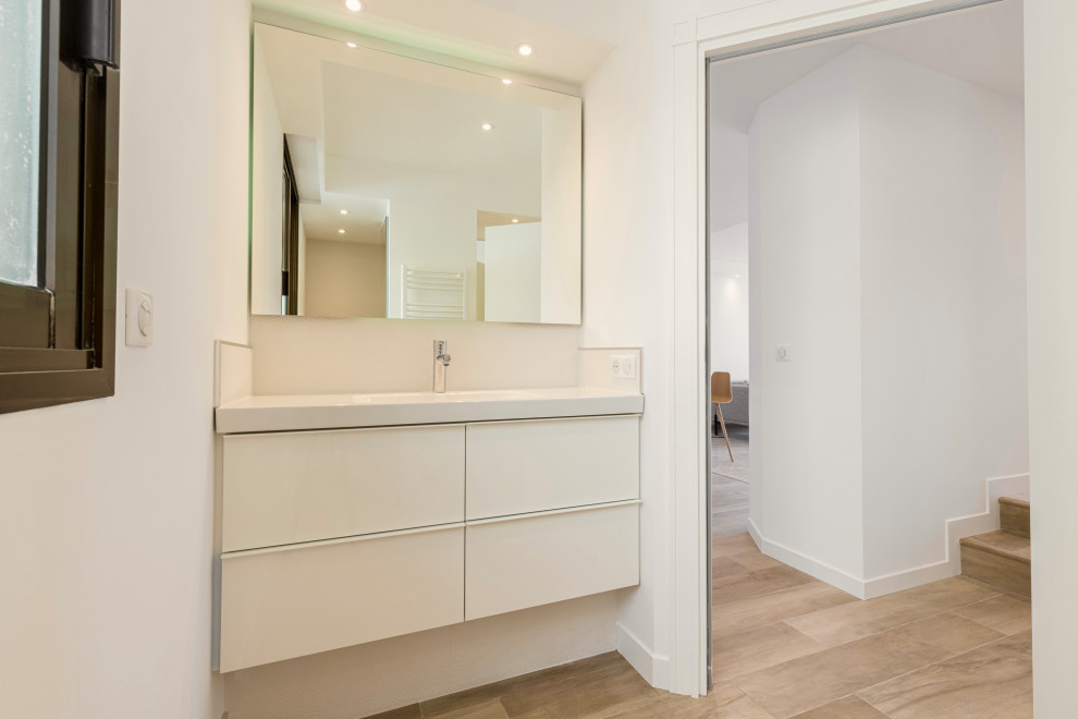 Inspiration for a mid-sized contemporary 3/4 beige floor, single-sink, ceramic tile and tray ceiling walk-in shower remodel in Nice with a trough sink, white countertops, a floating vanity, white cabinets, white walls and solid surface countertops