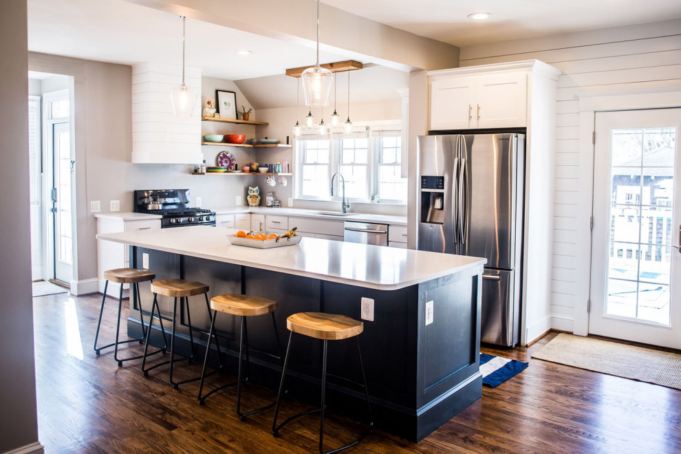 Example of a transitional galley dark wood floor eat-in kitchen design in Baltimore with shaker cabinets, stainless steel appliances, an island and white countertops