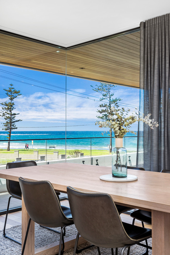 Design ideas for a large contemporary dining room in Wollongong with medium hardwood floors and brown floor.