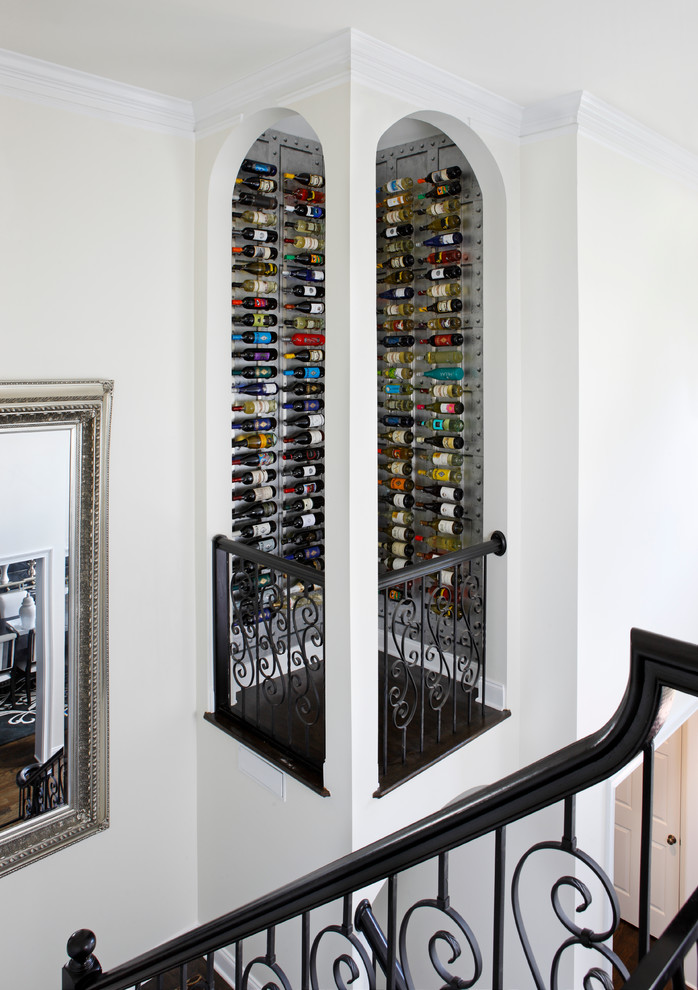 Large transitional wine cellar in Atlanta with dark hardwood floors, display racks and black floor.