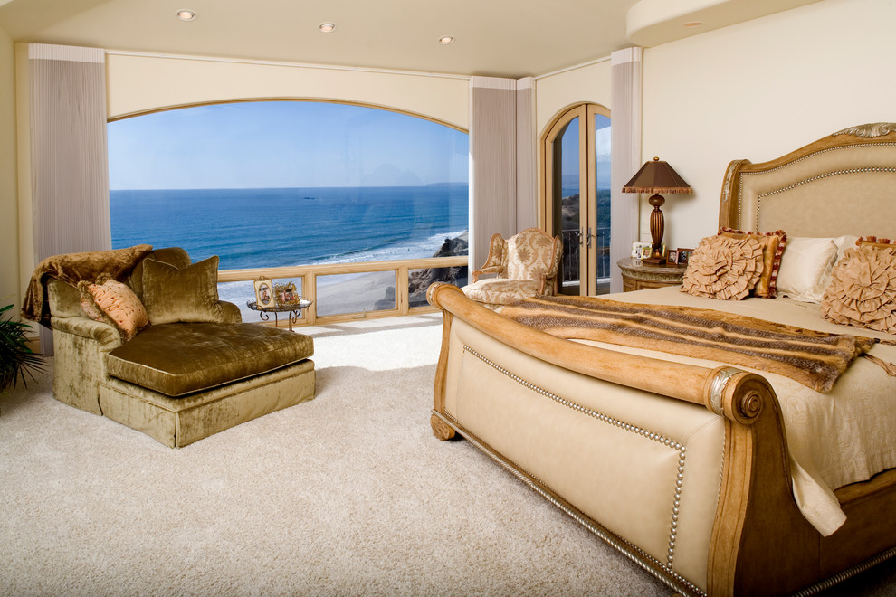 This is an example of a traditional bedroom in Orange County with beige walls, carpet and beige floor.