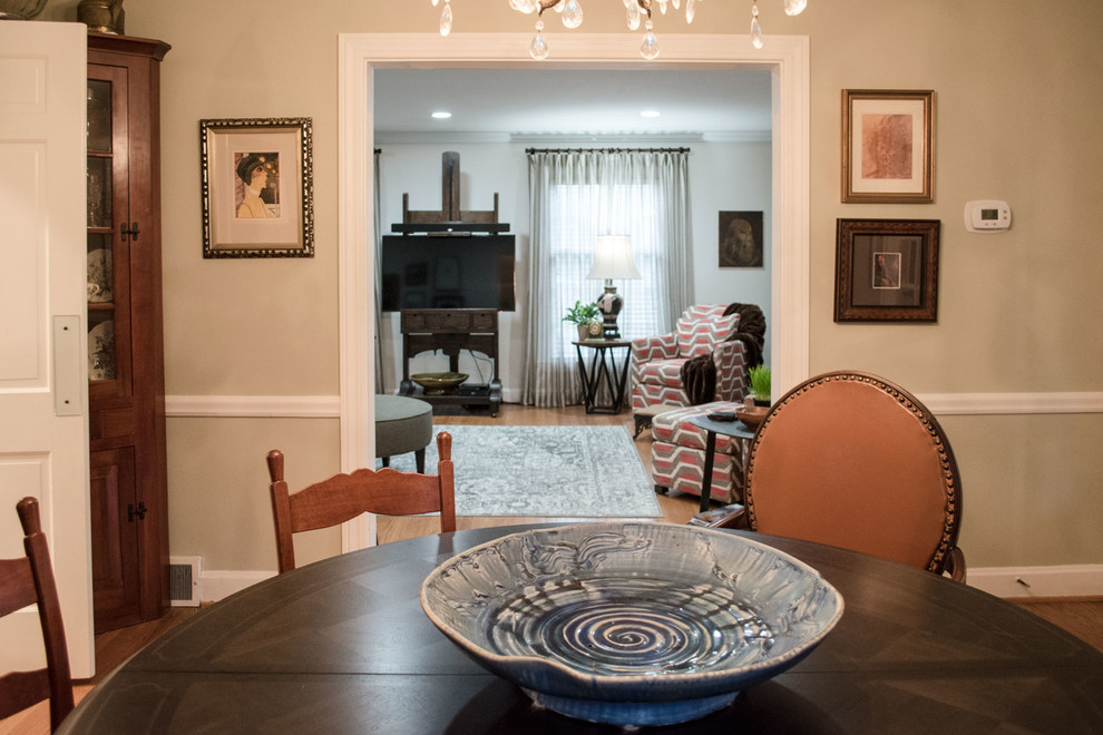 Inspiration for a mid-sized eclectic separate dining room in Louisville with beige walls, medium hardwood floors and orange floor.