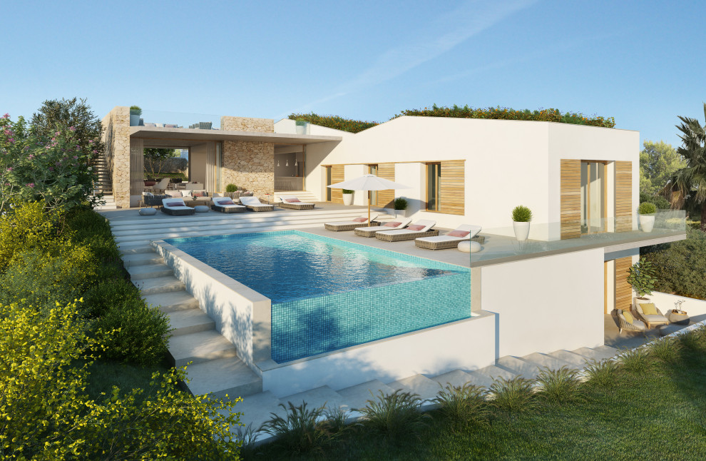 Ispirazione per una grande piscina a sfioro infinito mediterranea rettangolare davanti casa con paesaggistica bordo piscina e piastrelle