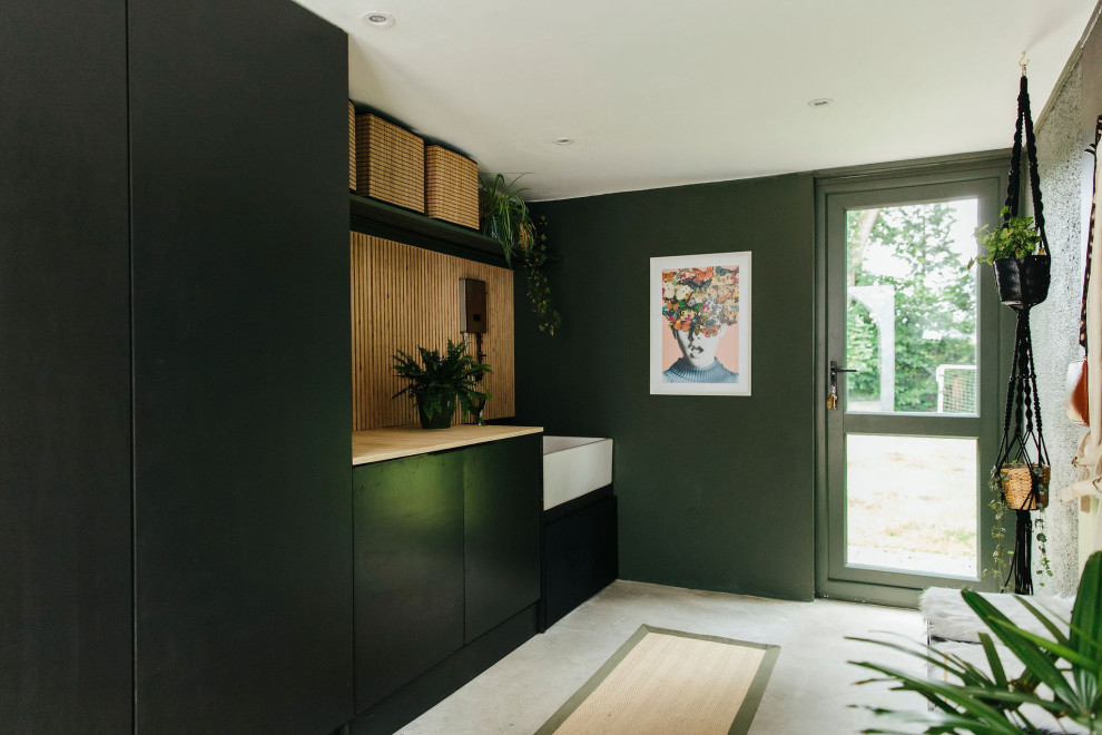 Design ideas for a large midcentury boot room in Hampshire with green walls.