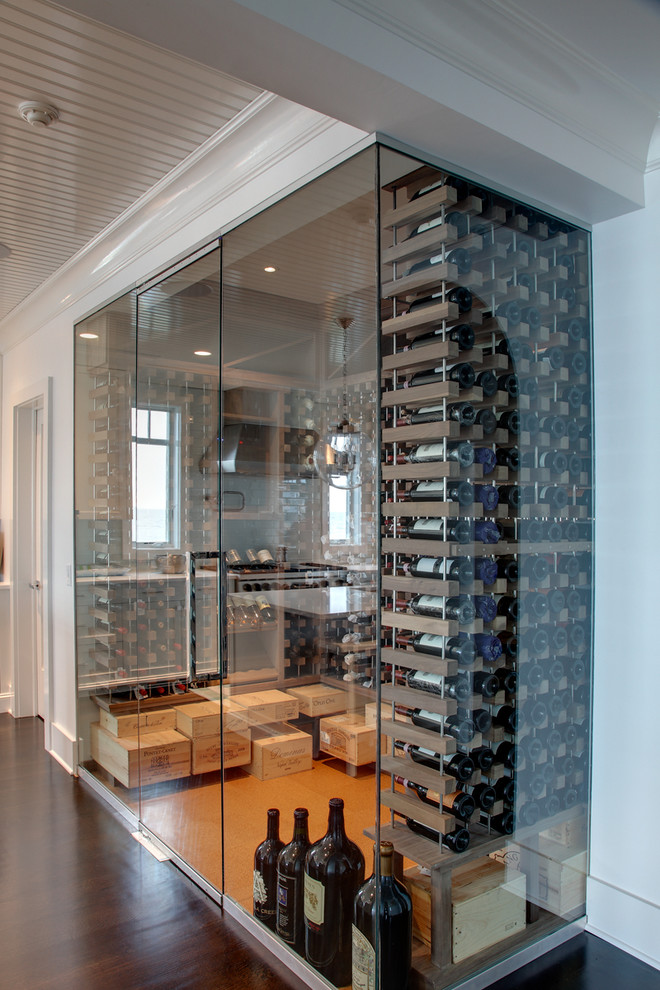 Inspiration for a beach style wine cellar in New York with cork floors and storage racks.