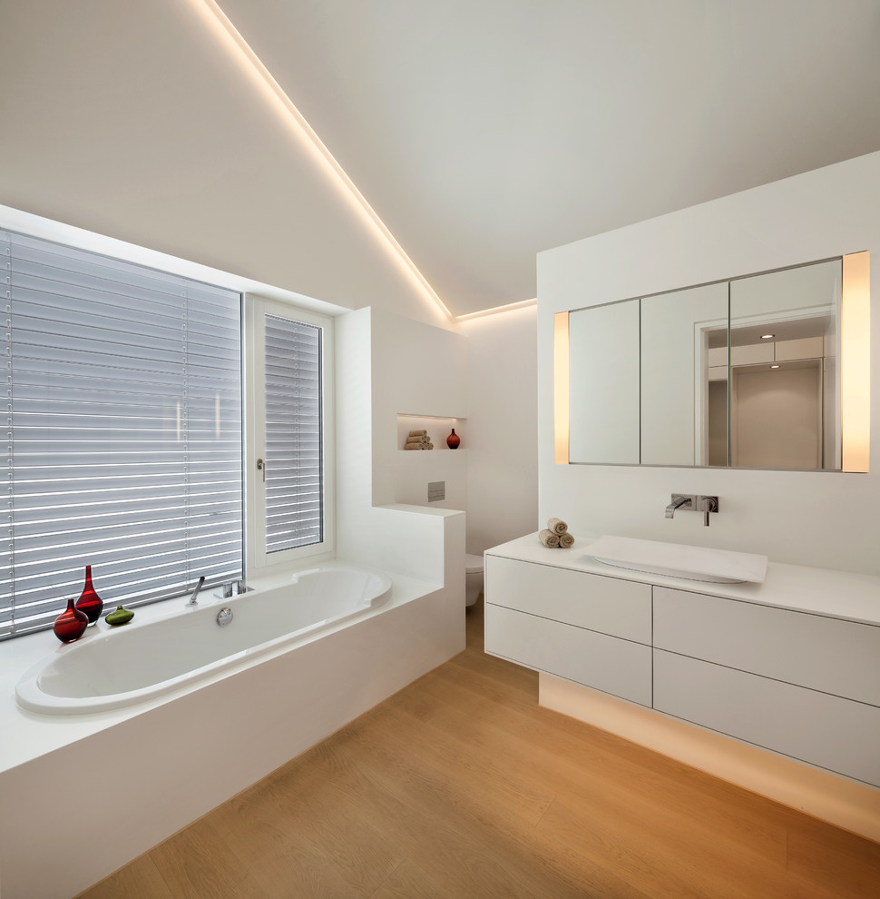 This is an example of a contemporary bathroom in Other with a vessel sink and a drop-in tub.