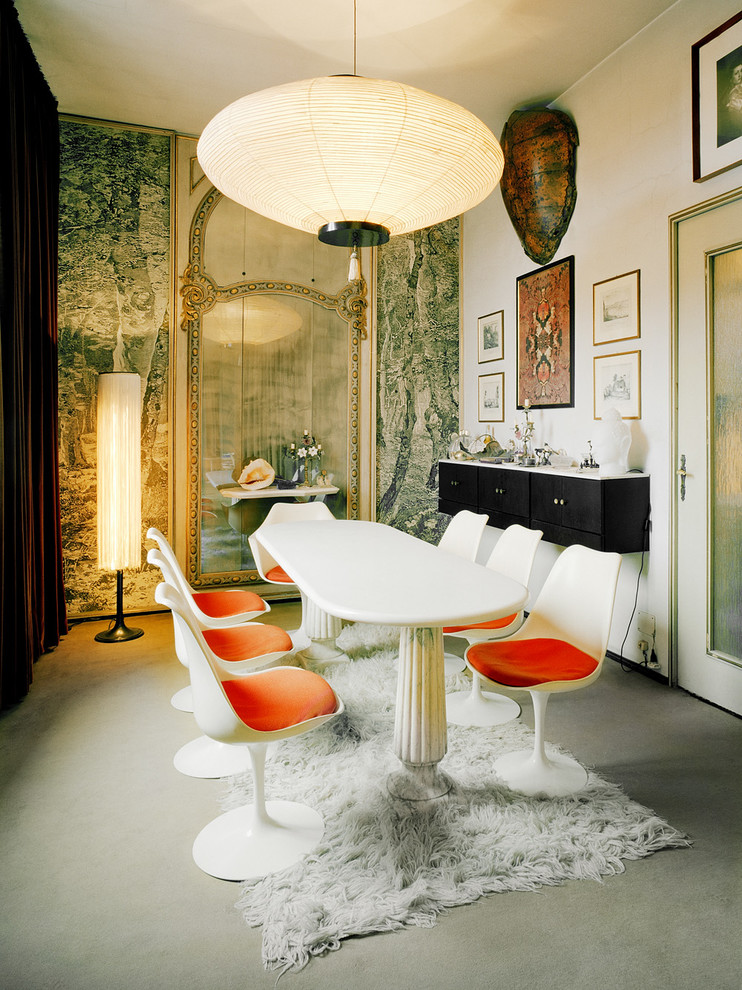 Photo of an eclectic dining room in Turin with white walls and carpet.