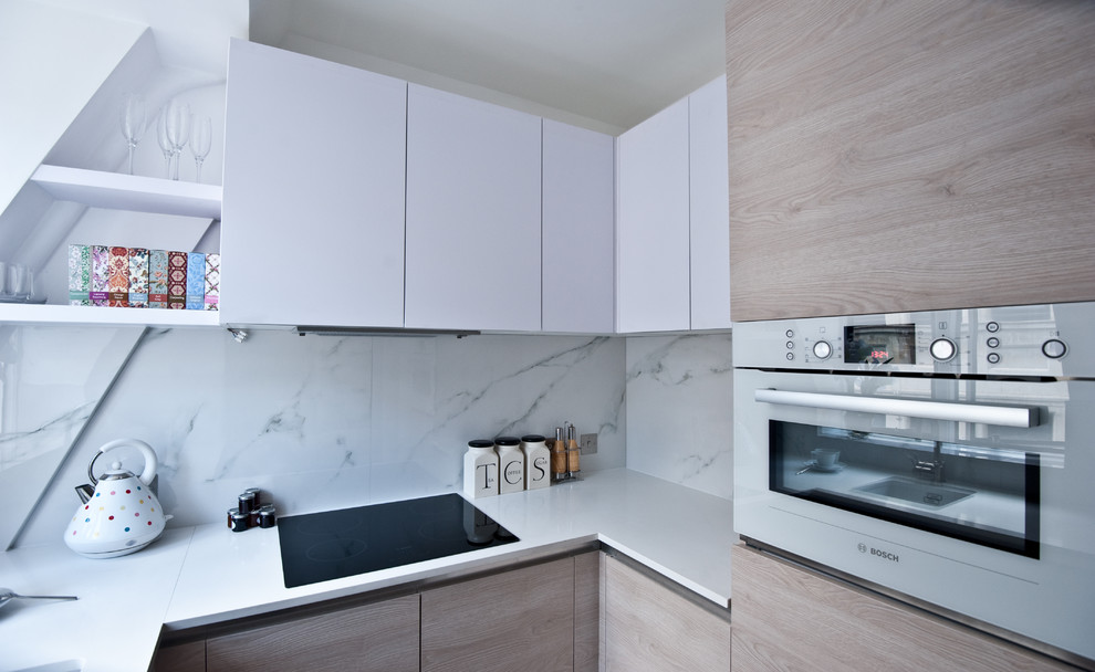 Design ideas for a small modern u-shaped open plan kitchen in London with an undermount sink, flat-panel cabinets, white cabinets, quartz benchtops, white splashback, stone tile splashback, stainless steel appliances, dark hardwood floors and no island.