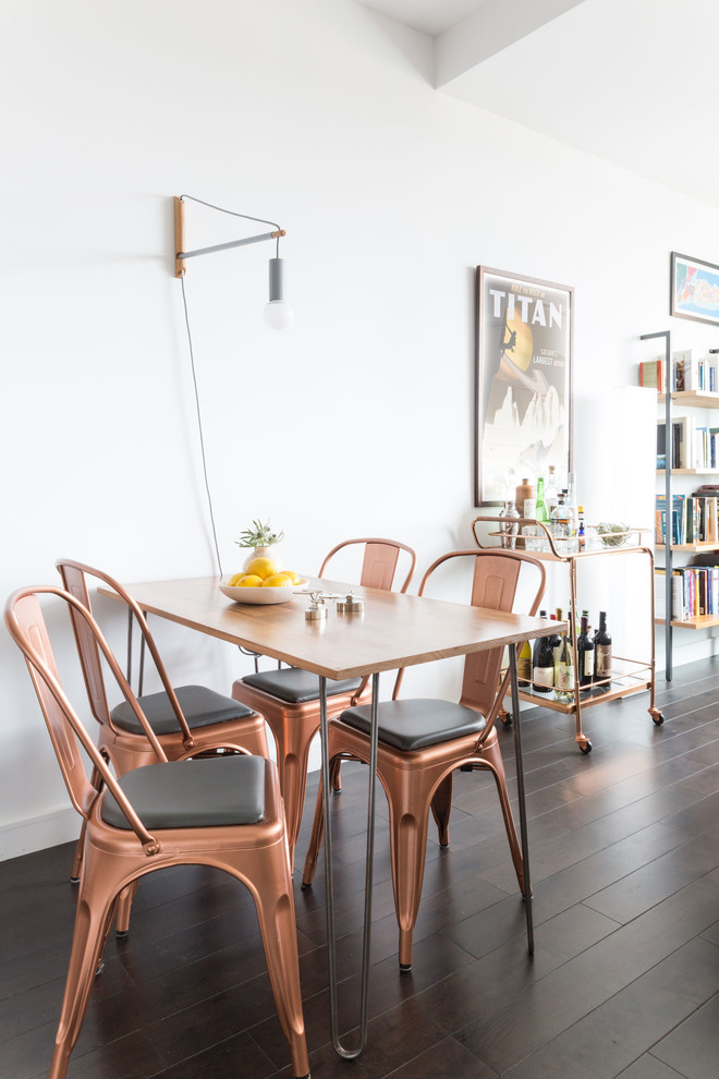Photo of a small midcentury dining room in New York with white walls and dark hardwood floors.