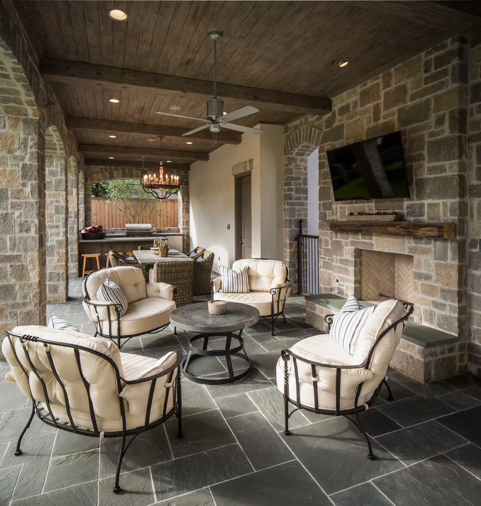 Design ideas for a traditional patio in Houston with a fire feature and a roof extension.