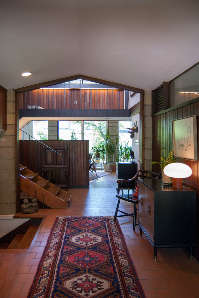 Inspiration for a midcentury entryway in Philadelphia with terra-cotta floors.