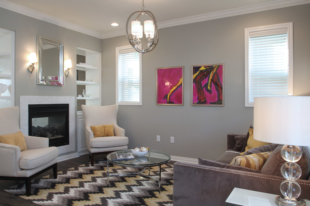 Photo of a small transitional formal open concept living room in Cedar Rapids with grey walls, laminate floors, a two-sided fireplace, a tile fireplace surround and no tv.