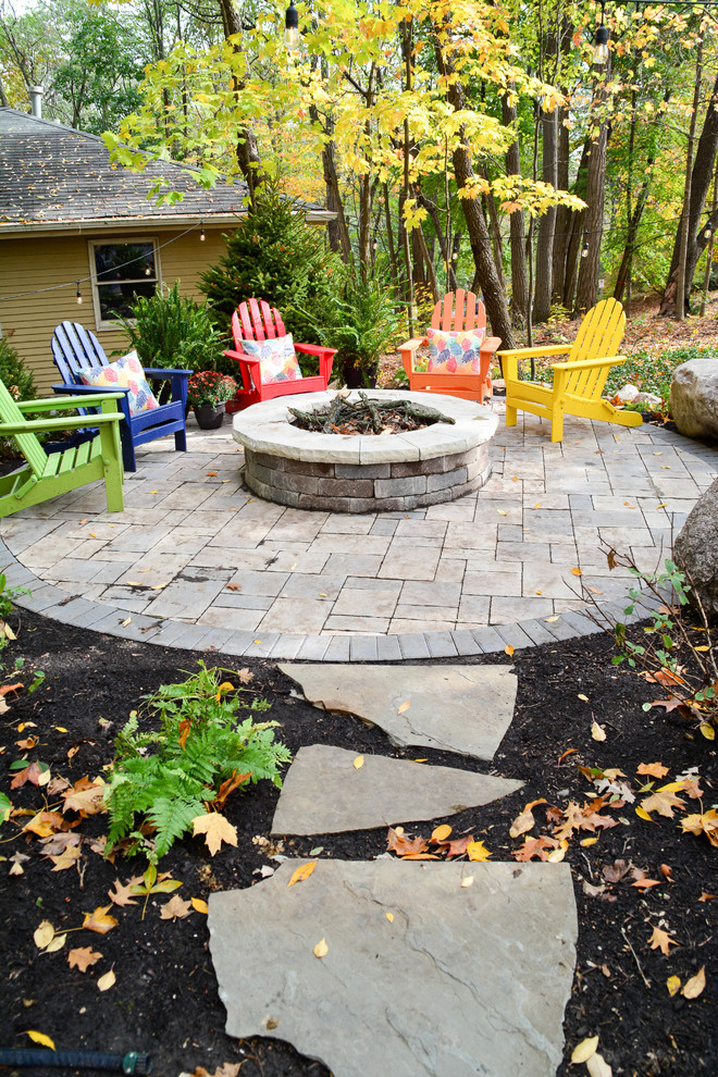 Transitional backyard patio in Chicago with brick pavers.