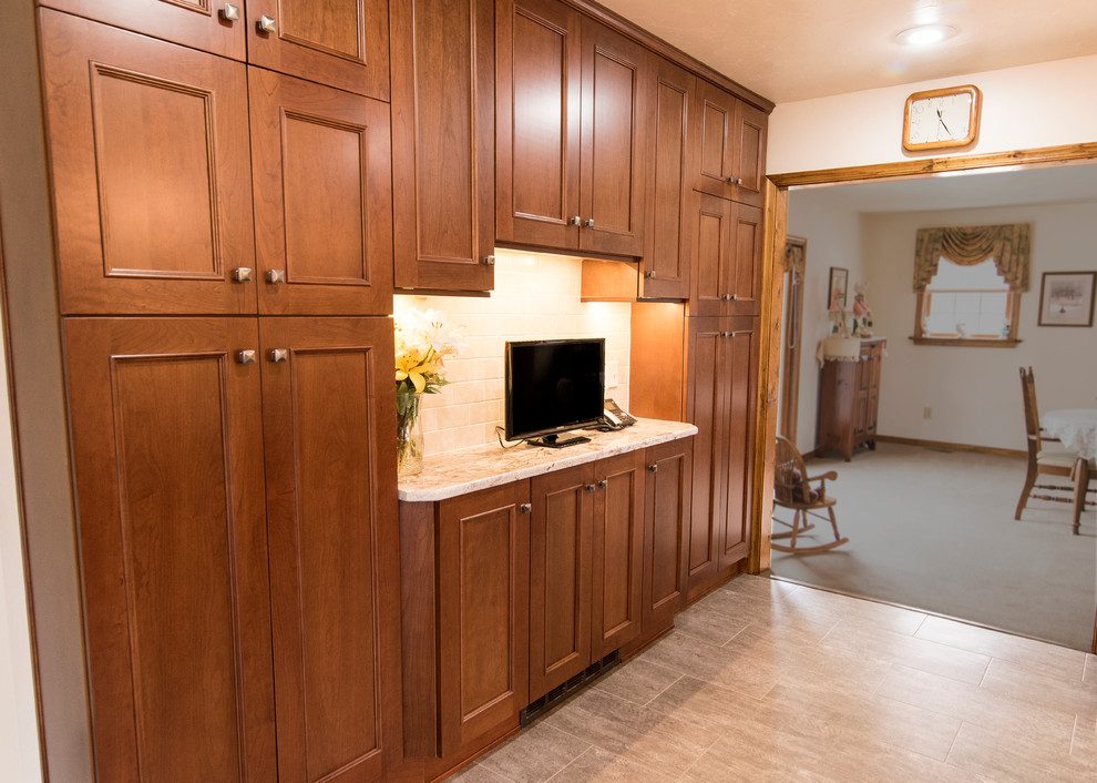 Large elegant l-shaped vinyl floor and beige floor eat-in kitchen photo in Baltimore with an undermount sink, shaker cabinets, medium tone wood cabinets, granite countertops, beige backsplash, ceramic backsplash, stainless steel appliances, an island and white countertops