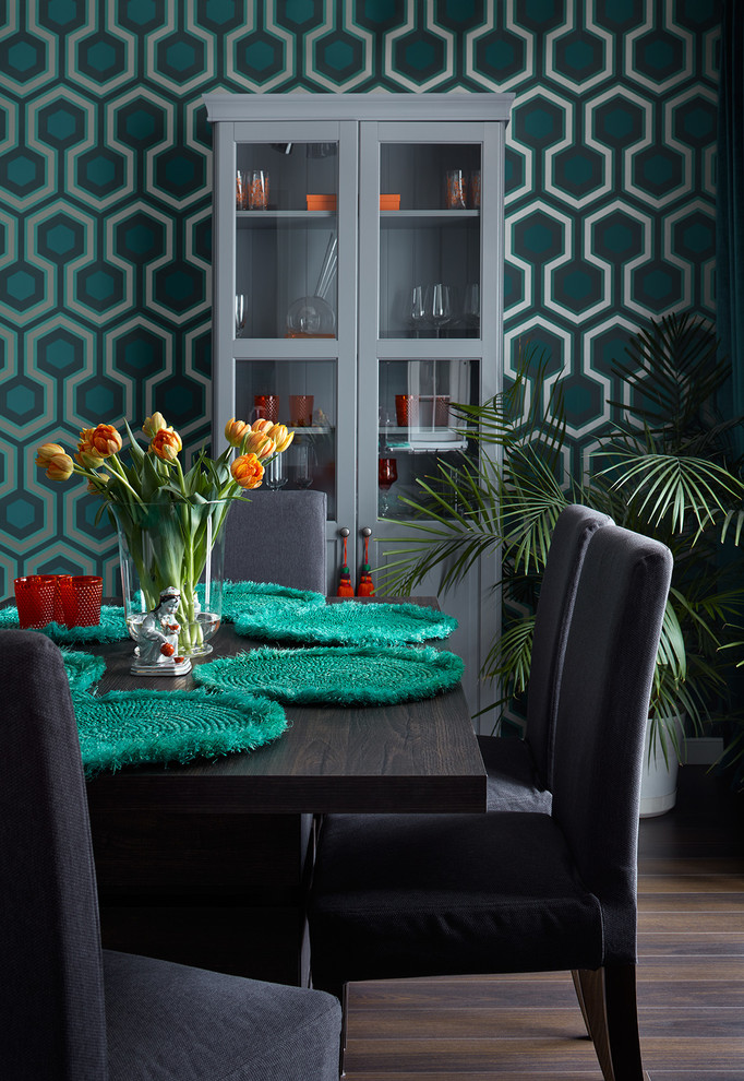 This is an example of a contemporary dining room in Moscow with green walls and dark hardwood floors.