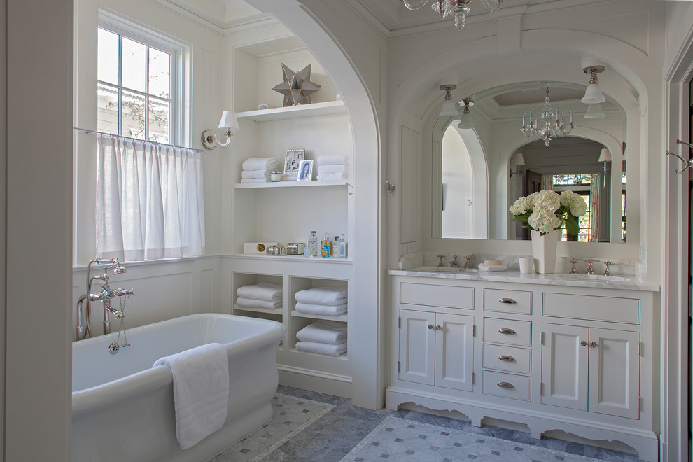 This is an example of a beach style master bathroom in Other with recessed-panel cabinets, white cabinets, a freestanding tub, a shower/bathtub combo, white walls, an undermount sink, grey floor and an open shower.
